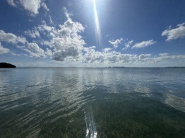 A scenic view of calm waters and a cloudy sky, capturing the tranquility of a boating destination.