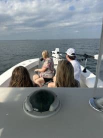 A group of guests enjoys a scenic boat ride, taking in the views of the open water — perfect for a day of adventure on the sea.