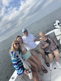 A cheerful group of family members enjoys a day on the boat, capturing memories with smiles and laughter on the water.