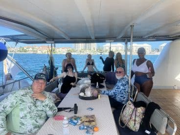 A lively group enjoys drinks and camaraderie aboard a boat, perfect for celebrations and memorable outings on the water.