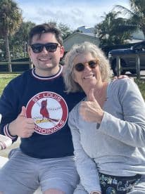A cheerful duo gives thumbs up while enjoying a sunny day outdoors, perfect for capturing memorable moments with friends or family.