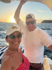 A couple enjoys a beautiful sunset on a boat, capturing a perfect moment of joy and togetherness — ideal for romantic outings or special celebrations.