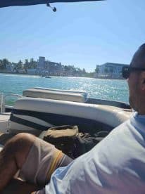 A relaxing moment on a boat with scenic views of waterfront properties, perfect for enjoying a day on the water.