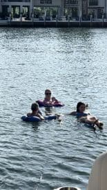 A group of friends enjoys a relaxing day floating in the water, perfect for summer fun and leisure activities on the water.