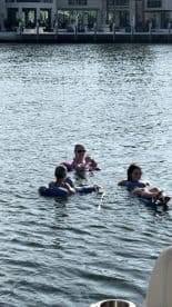 A group enjoys a relaxing day floating in the water, showcasing the perfect summer fun and camaraderie on the water.