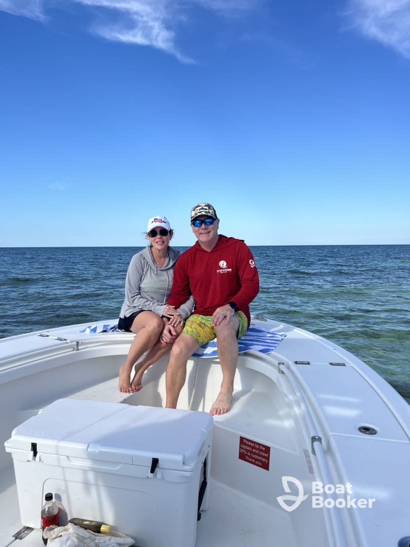 A couple enjoys a sunny day on the boat, capturing a moment of relaxation on the open water — perfect for romantic getaways or fun outings.