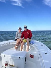 A couple enjoys a sunny day on the boat, capturing a moment of relaxation on the open water — perfect for romantic getaways or fun outings.