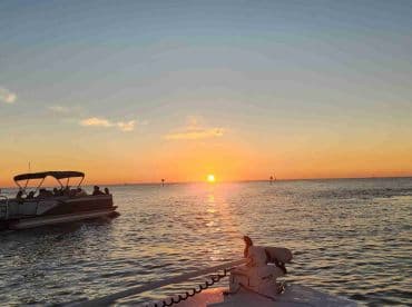 A picturesque sunset view with a group enjoying a boat ride, creating a perfect backdrop for memorable moments on the water.