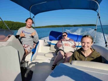 A cheerful group enjoys a day on the water, capturing the essence of fun and adventure aboard their boat.