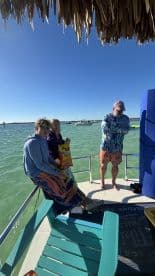 A group of friends relaxes on a boat, enjoying snacks and the beautiful water views — perfect for a day of fun on the water.