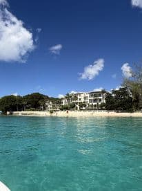 A picturesque view of a luxurious beachfront property with clear turquoise waters, perfect for showcasing stunning coastal destinations.