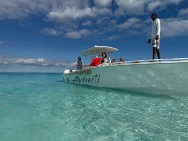 A lively group enjoys a day on the water aboard the Avanti, surrounded by crystal-clear ocean waters — perfect for adventure and relaxation.