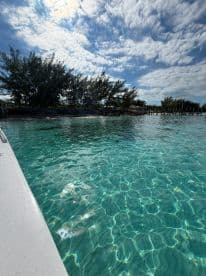 A stunning view of crystal-clear turquoise waters and a picturesque coastline, perfect for showcasing the beauty of a boating adventure.