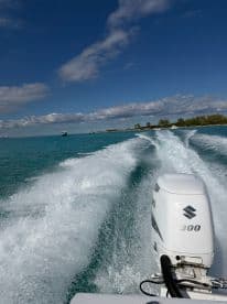A dynamic view of a speedboat cutting through turquoise waters, showcasing the thrill of boating in a picturesque setting.
