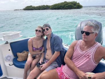 A group of friends relaxes on a boat, enjoying the beautiful ocean views — perfect for a day of adventure and fun on the water.