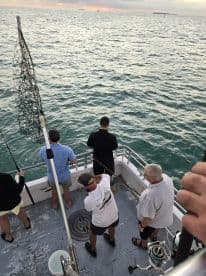 A group of anglers enjoys a fishing trip on the water, showcasing camaraderie and excitement as they cast their lines into the sea.