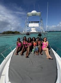 A vibrant group of friends enjoys a sunny day on a yacht, showcasing the perfect backdrop for celebrations and fun on the water.