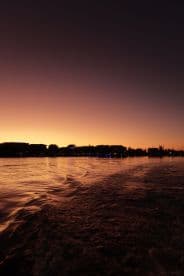 A stunning sunset view over the water, showcasing the tranquil beauty of the evening sky as the boat leaves a gentle wake.