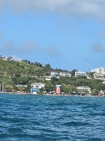 A scenic view of a vibrant coastline with colorful buildings and lush greenery, showcasing the beauty of island life.