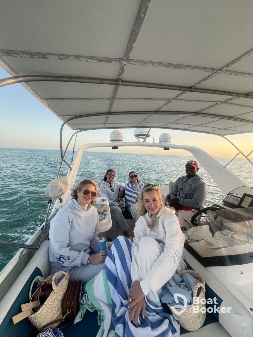 A group of friends enjoys a relaxing moment aboard a boat, perfect for sunset cruises and memorable gatherings on the water.