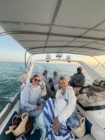 A group of friends enjoys a relaxing moment aboard a boat, perfect for sunset cruises and memorable gatherings on the water.