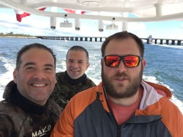A group of friends enjoys a day out on the water, capturing the excitement of their boating adventure with smiles and camaraderie.