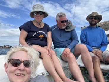 A group of friends enjoys a relaxing moment aboard a boat, showcasing camaraderie and the joy of being on the water.