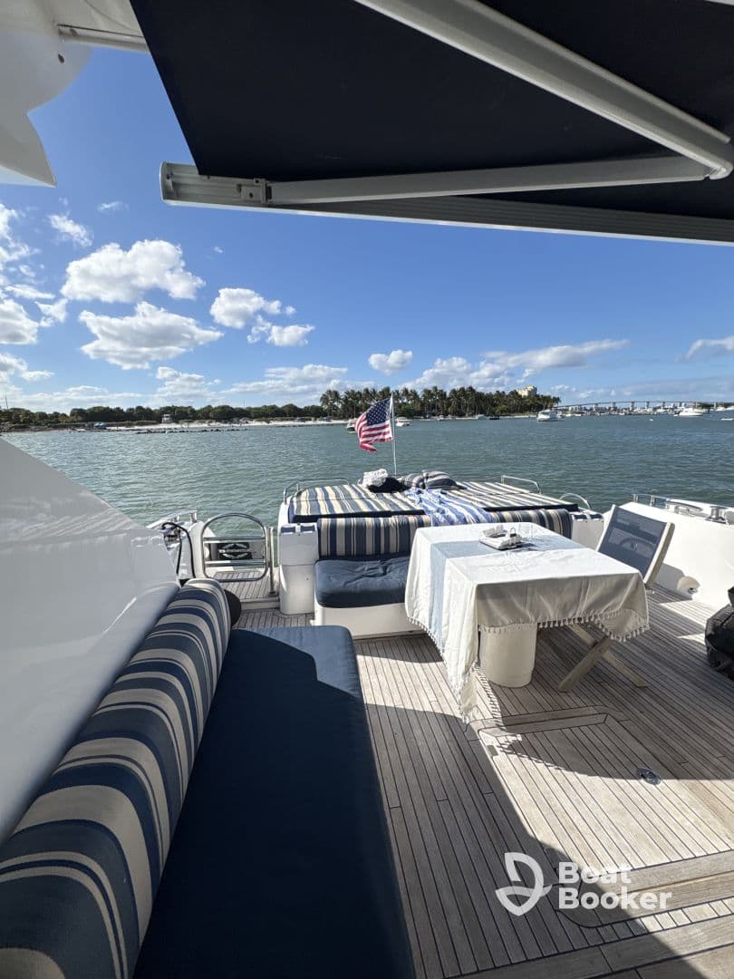 A cozy interior view of a yacht's dining area, featuring comfortable seating and a table set for relaxation, perfect for enjoying meals while cruising.