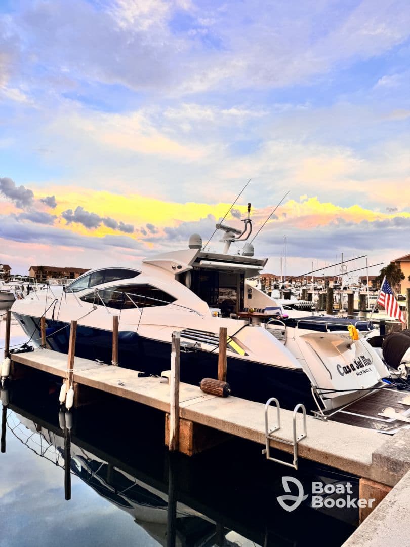 A stunning yacht docked at sunset, reflecting the vibrant colors of the sky in the calm waters — an ideal setting for luxury boating experiences.