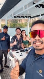 A cheerful group of four poses for a selfie on a boat, showcasing their excitement for the adventure ahead. Perfect for capturing memorable moments on the water.