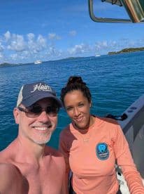 A cheerful selfie of two individuals aboard a boat, enjoying a sunny day on the ocean — perfect for capturing memorable moments during a boating adventure.
