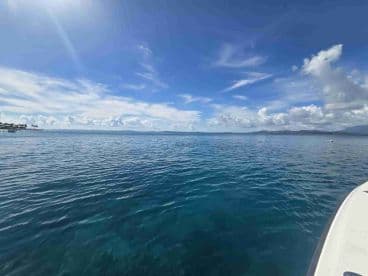 A serene view of calm waters and a clear sky, capturing the tranquility of a boating experience.
