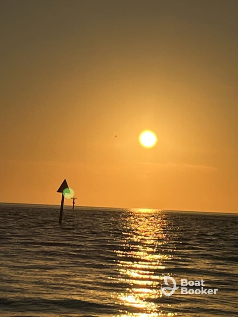 A stunning sunset over the ocean, with shimmering reflections on the water, creating a picturesque scene perfect for romantic evenings or peaceful getaways.