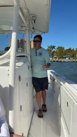 A captain navigates the helm of a boat, showcasing the interior design and functionality of the vessel — perfect for those interested in boating experiences.