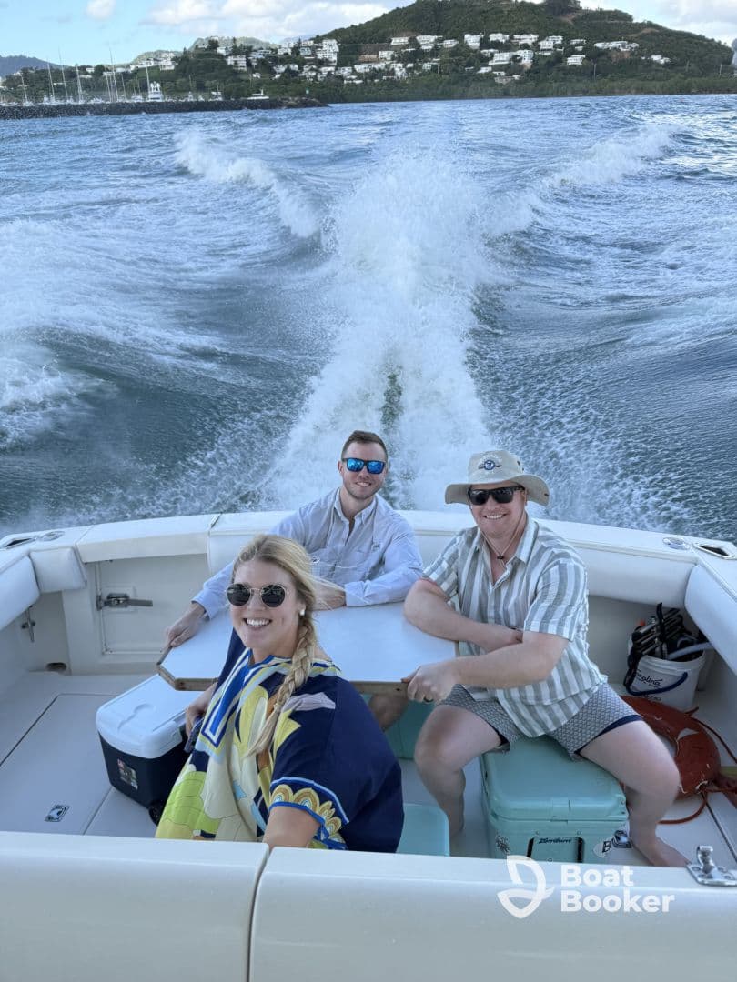 A cheerful group enjoys a day on the water, capturing the essence of fun and adventure aboard their boat.
