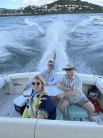 A cheerful group enjoys a day on the water, capturing the essence of fun and adventure aboard their boat.