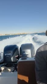 A thrilling view from the back of a boat as it speeds through the water, showcasing the powerful engines and the excitement of being on the water.