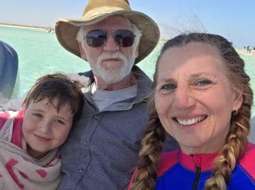 A joyful family selfie on a boat, capturing smiles and togetherness against a beautiful water backdrop — perfect for family outings and adventures.