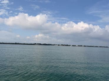A scenic view of calm waters and clouds, but the image lacks clarity and focus.