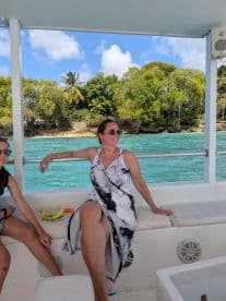 A woman and a child relax on a boat, enjoying the beautiful ocean view — perfect for a day of snorkeling and family fun.