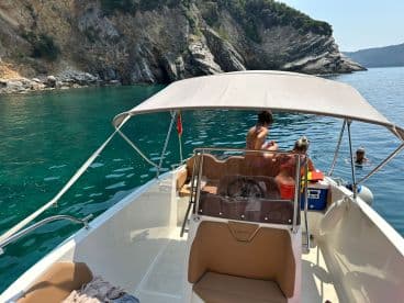 A group enjoys a refreshing swim in crystal-clear waters while relaxing on their boat, capturing the essence of summer fun and adventure.