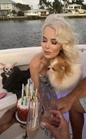 A birthday celebration on a boat featuring a cake with candles and champagne toasts, creating a festive atmosphere perfect for memorable moments on the water.