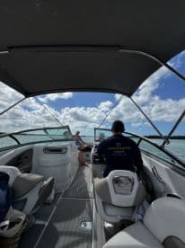 Inside view of a boat's helm area, showcasing comfortable seating and a relaxed atmosphere, perfect for enjoying a day on the water.