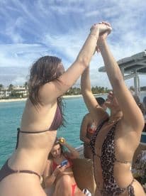 A joyful group of friends celebrates on a boat, showcasing fun and camaraderie under the sun — perfect for memorable outings and adventures on the water.