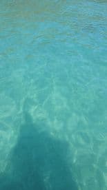 An unclear image of turquoise water, lacking identifiable features or subjects.