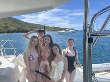 A group of friends poses on a boat, ready for a snorkeling adventure in crystal-clear waters — perfect for summer fun and aquatic exploration.