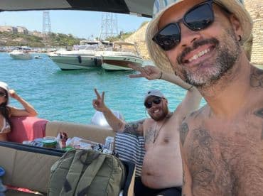 A fun group enjoys a day on the water, capturing smiles and good vibes aboard their boat — perfect for summer celebrations and memorable outings.