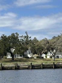 A view of a waterfront property with trees and a dock, but the image lacks clarity and detail.