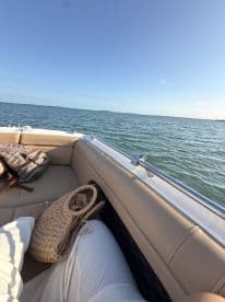 A cozy view from inside a boat, showcasing comfortable seating and a serene ocean backdrop — perfect for relaxing on the water.