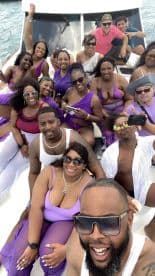 A lively group enjoys a fun day on the water, celebrating together aboard a boat, showcasing the perfect atmosphere for parties and gatherings.
